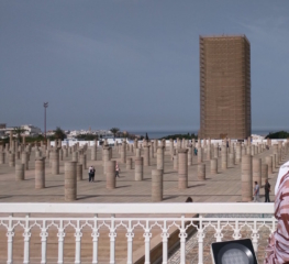 Outside Mausoleum of Mohammed V.  Hassan Tower in the background. Currently under renovation, so covered in scaffolding.